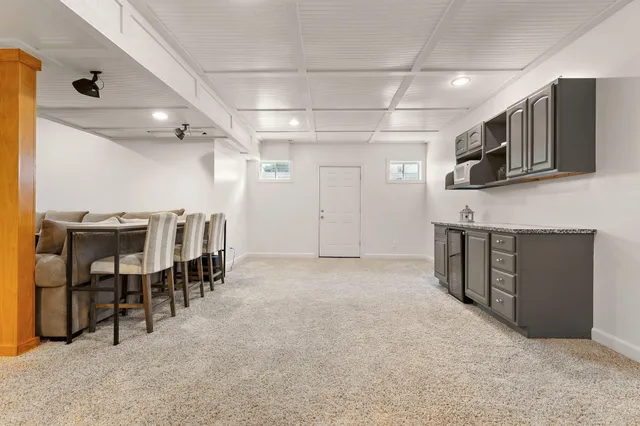 a backyard of a house with table and chairs