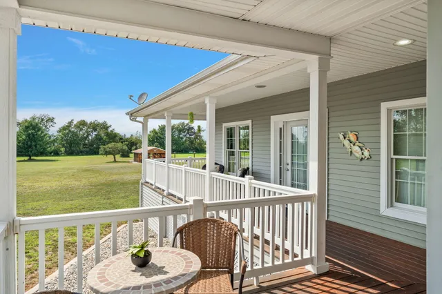 an aerial view of residential houses with outdoor space and trees all around