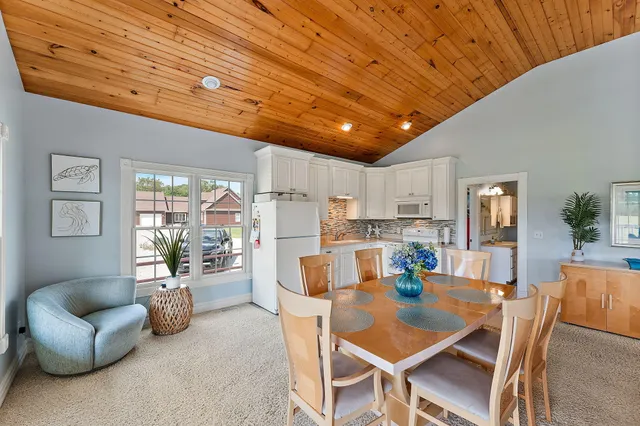 a front view of a house with a yard table and chairs
