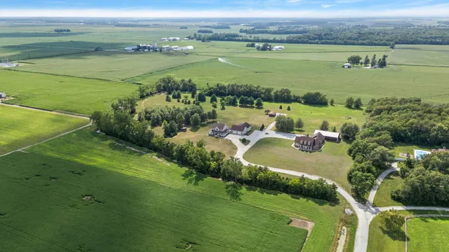 a view of a house with a garden and lake view