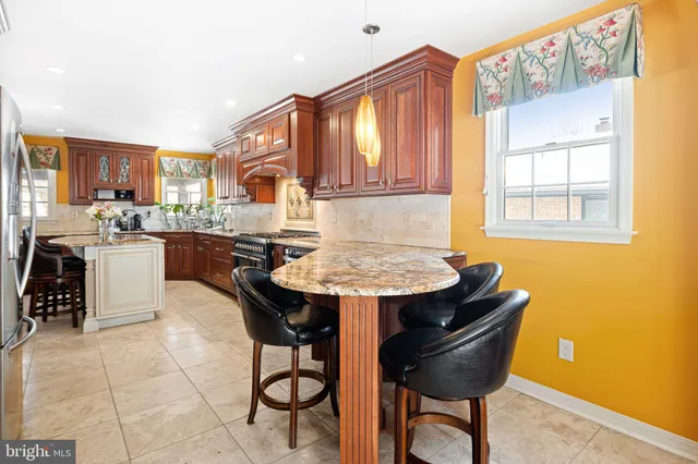 a kitchen with a stove a sink and a refrigerator