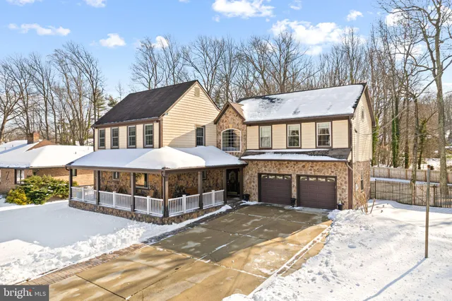 a front view of a house with yard and trees