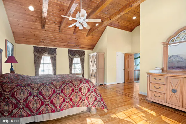 a bedroom with a large bed and a dresser