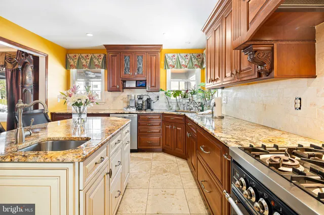 a kitchen with stainless steel appliances granite countertop a sink stove and cabinets