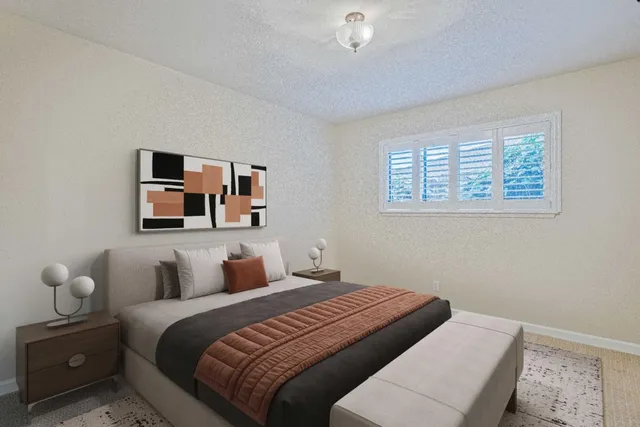 a bedroom with a bed and lamp