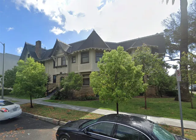 a view of a street with a car parked in front of it