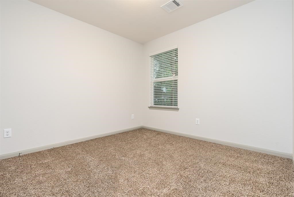 910 Shady Lane, Unit B Conroe, TX 77301 - Photo 15 of 18 an empty room with a window
