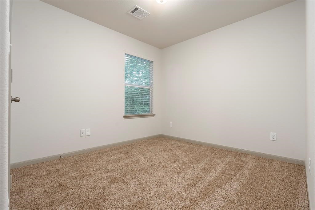 910 Shady Lane, Unit B Conroe, TX 77301 - Photo 16 of 18 an empty room with a window