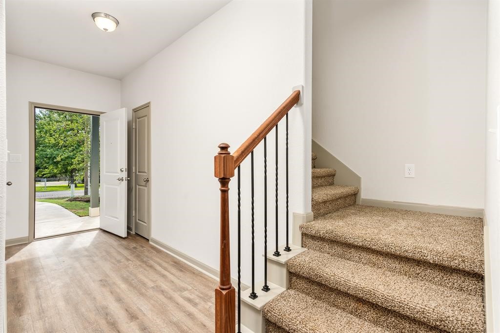 910 Shady Lane, Unit B Conroe, TX 77301 - Photo 3 of 18 a view of entryway and hall with wooden floor