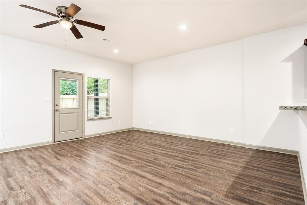 910 Shady Lane, Unit B Conroe, TX 77301 - Photo 9 of 18 a view of empty room with wooden floor and fan