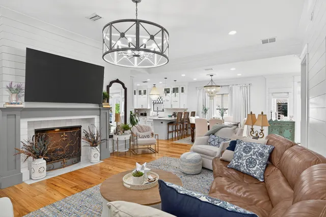 a living room with furniture a fireplace and a flat screen tv