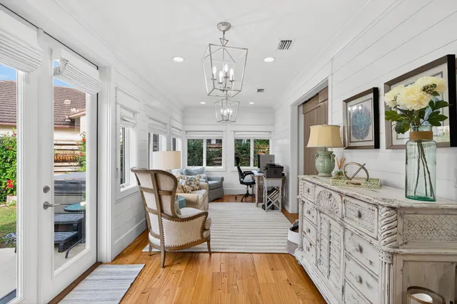 a living room with furniture and a chandelier