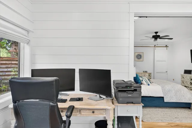 a spacious bedroom with a bed a couch and a flat screen tv