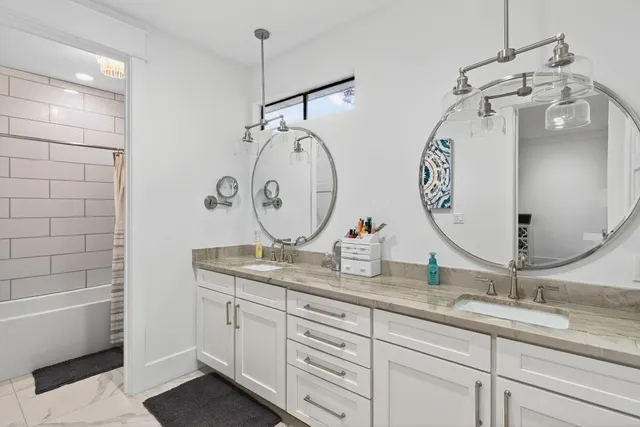 a living room with furniture and large windows