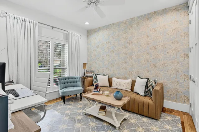 a kitchen with stainless steel appliances granite countertop a coffee maker a sink and white cabinets with wooden floor