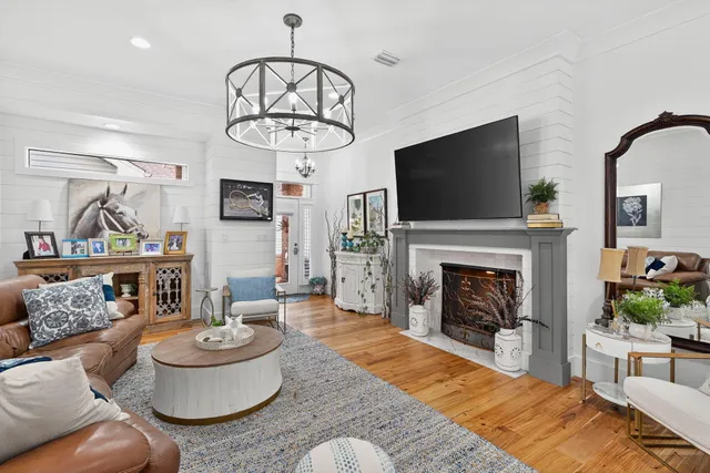 a living room with furniture a fireplace and a flat screen tv