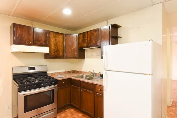 a kitchen with a refrigerator and a sink