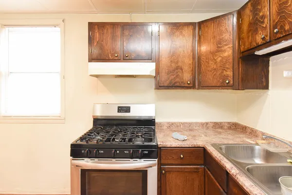 a stove top oven sitting inside of a kitchen