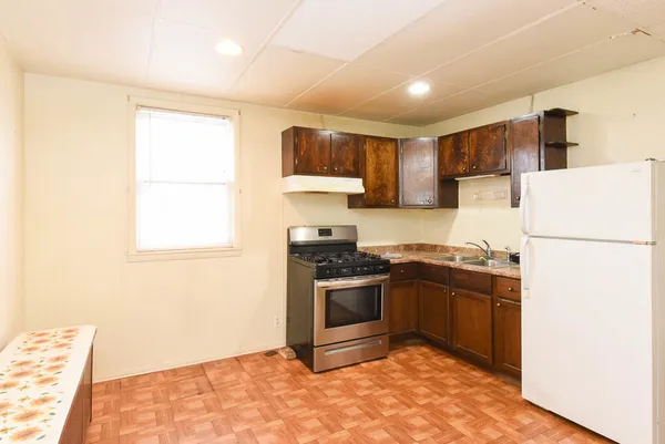 a kitchen with stainless steel appliances granite countertop a stove a refrigerator and a refrigerator
