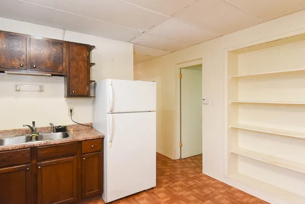 a kitchen with a refrigerator and a sink