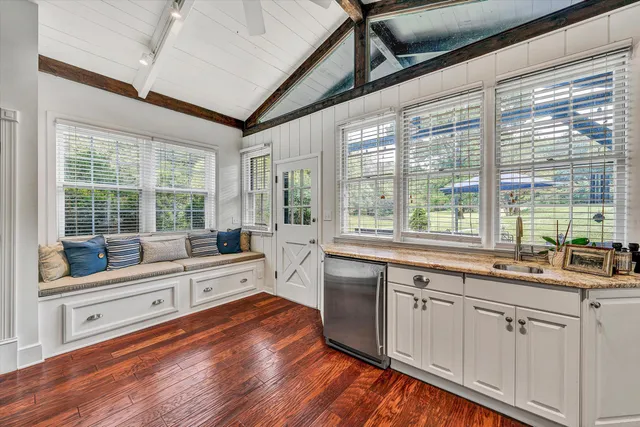 a living room with furniture a rug and a large window