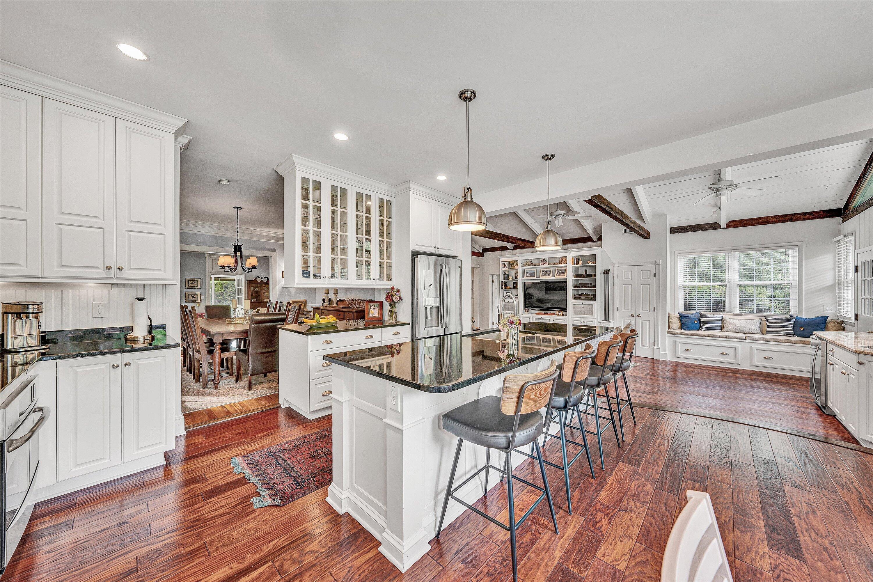400 Walnut Road Salem, VA 24153 - Photo 29 of 97 a open kitchen with stainless steel appliances granite countertop a stove top oven a refrigerator a dining table and chairs with wooden floor
