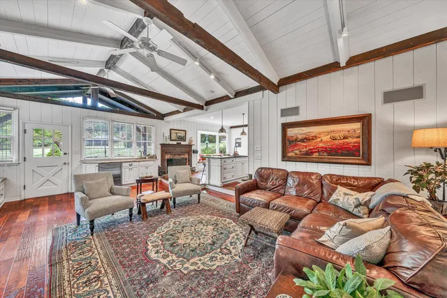 a view of a room that has a bed mirror and window