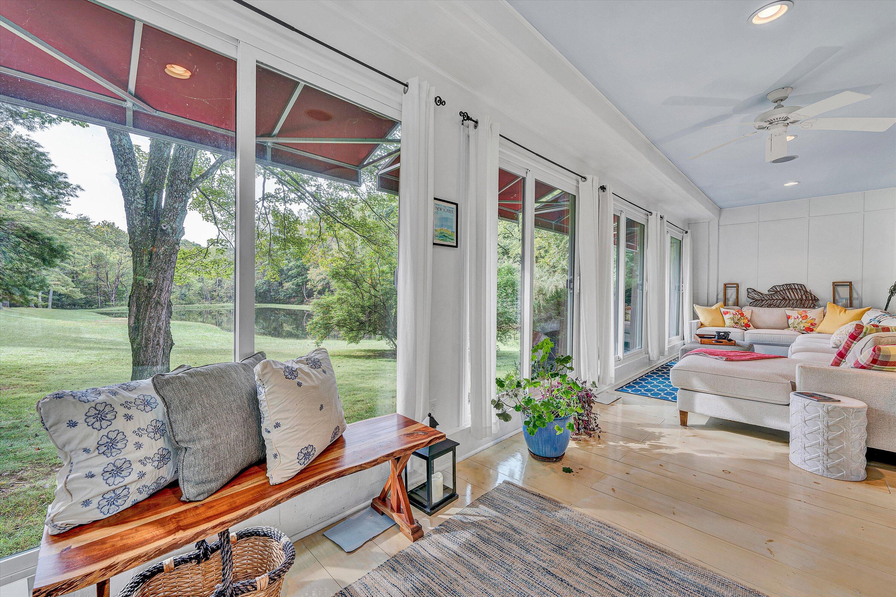 400 Walnut Road Salem, VA 24153 - Photo 42 of 97 a living room with furniture floor to ceiling window and wooden floor