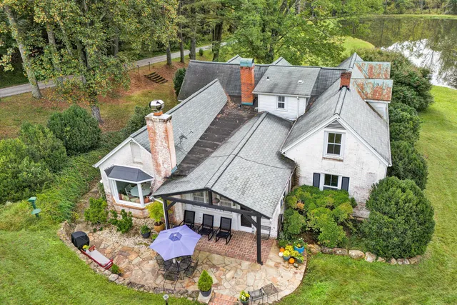 a very nice looking living room with a large window and wooden floor