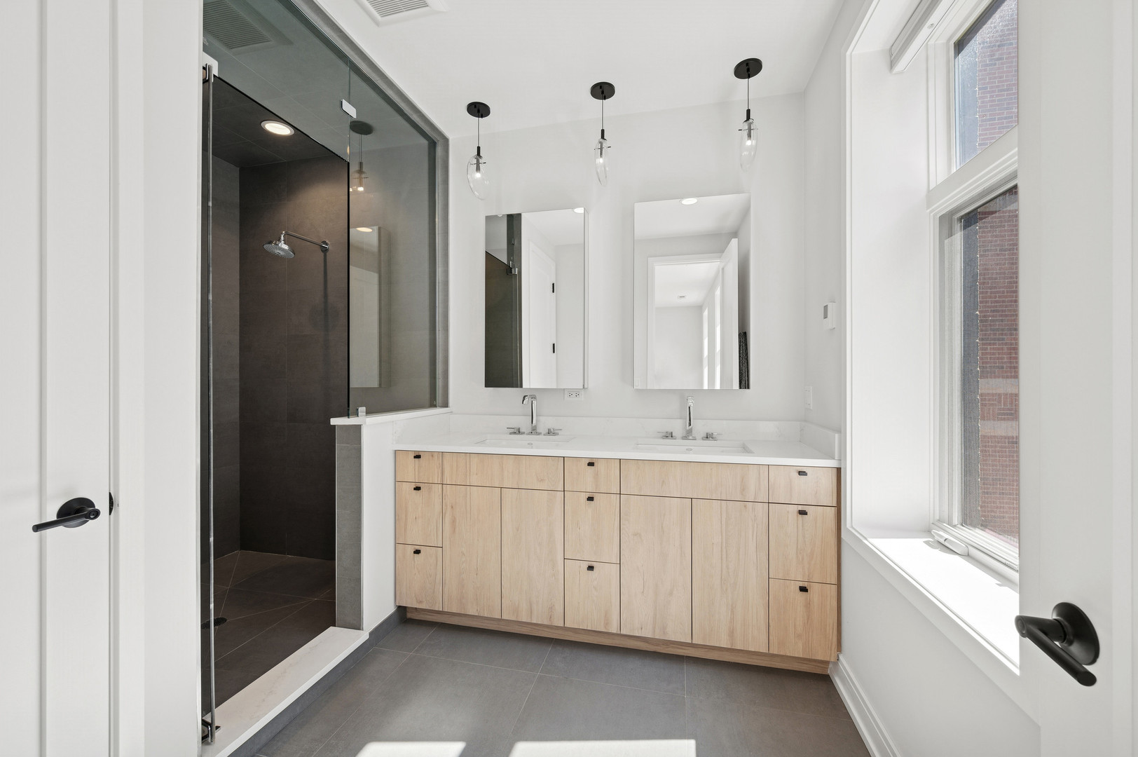 231 West Scott Street, Unit 2 Chicago, IL 60610 - Photo 16 of 33 a spacious bathroom with a double vanity sink a mirror and a bathtub