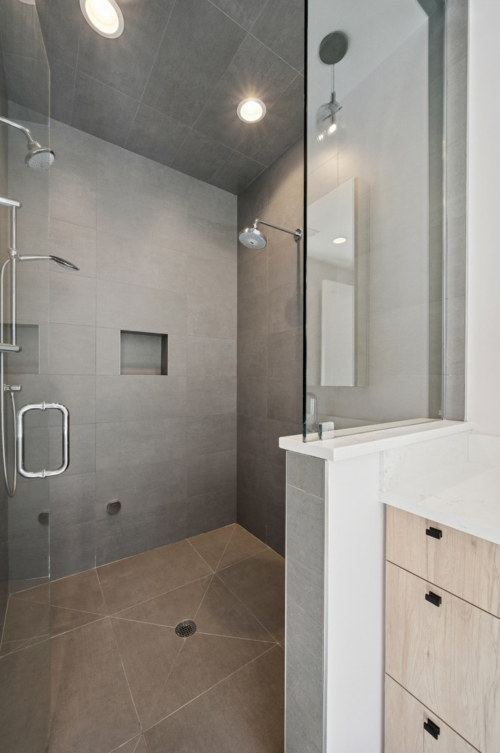 231 West Scott Street, Unit 2 Chicago, IL 60610 - Photo 17 of 33 a bathroom with a granite countertop sink a mirror and shower