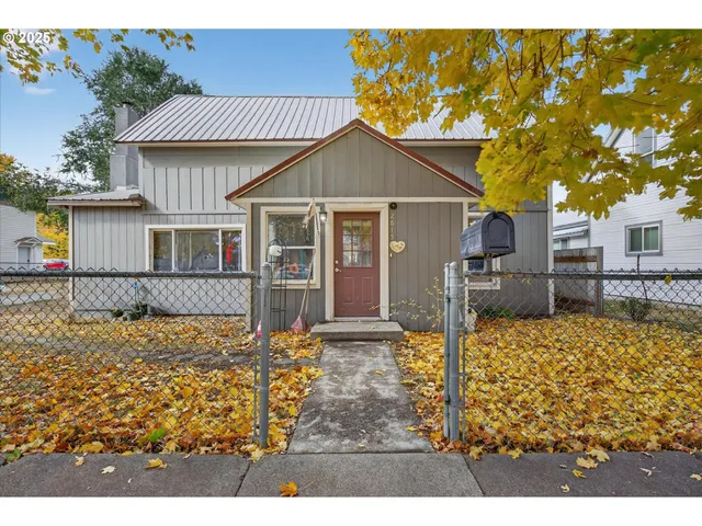 a view of a house with wooden fence