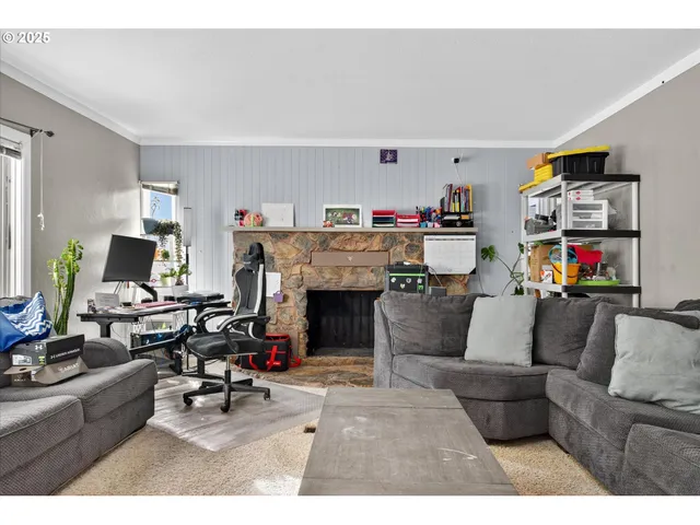 a living room with furniture and a fireplace