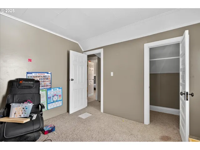 a bedroom with a bed and a painting on the wall