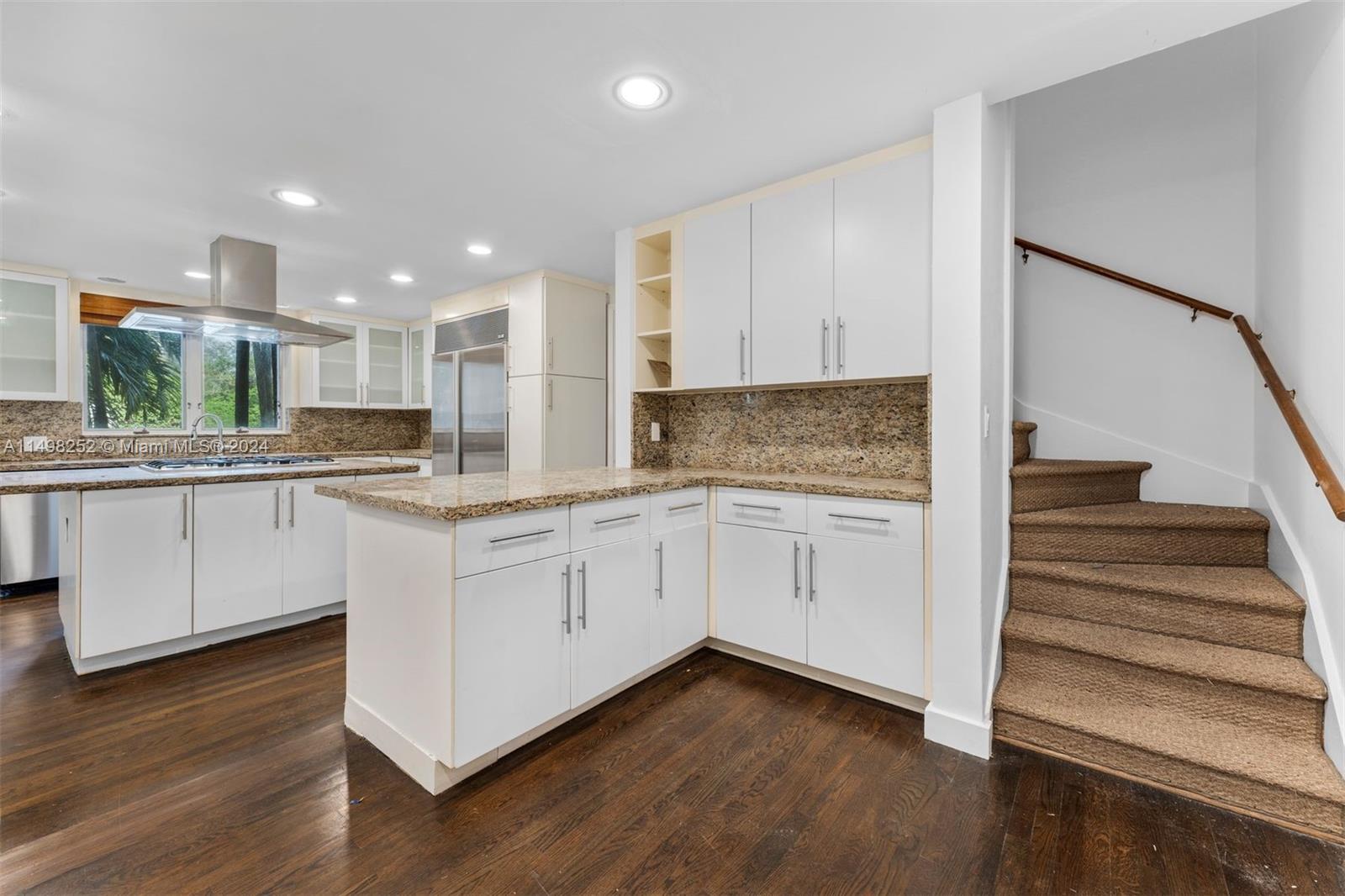 12 Lagorce Circle Miami Beach, FL 33141 - Photo 18 of 23 a kitchen with granite countertop white cabinets and white appliances