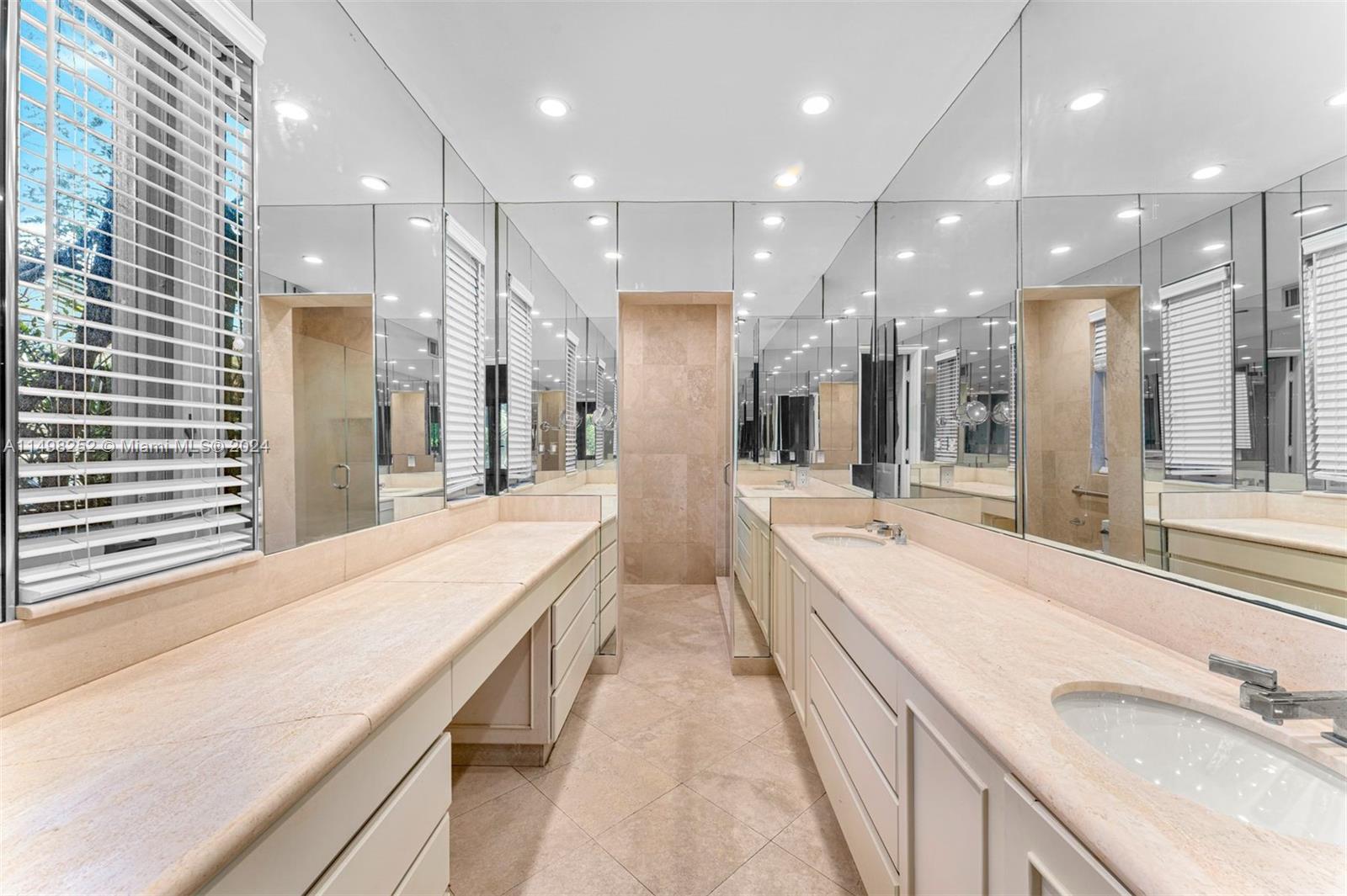 12 Lagorce Circle Miami Beach, FL 33141 - Photo 20 of 23 a large bathroom with double vanity and a large mirror