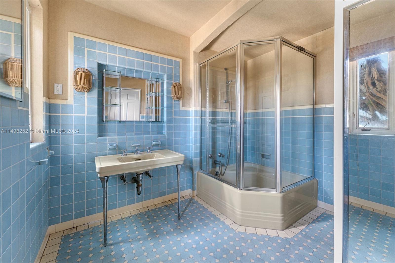 12 Lagorce Circle Miami Beach, FL 33141 - Photo 23 of 23 a bathroom with a sink and a mirror