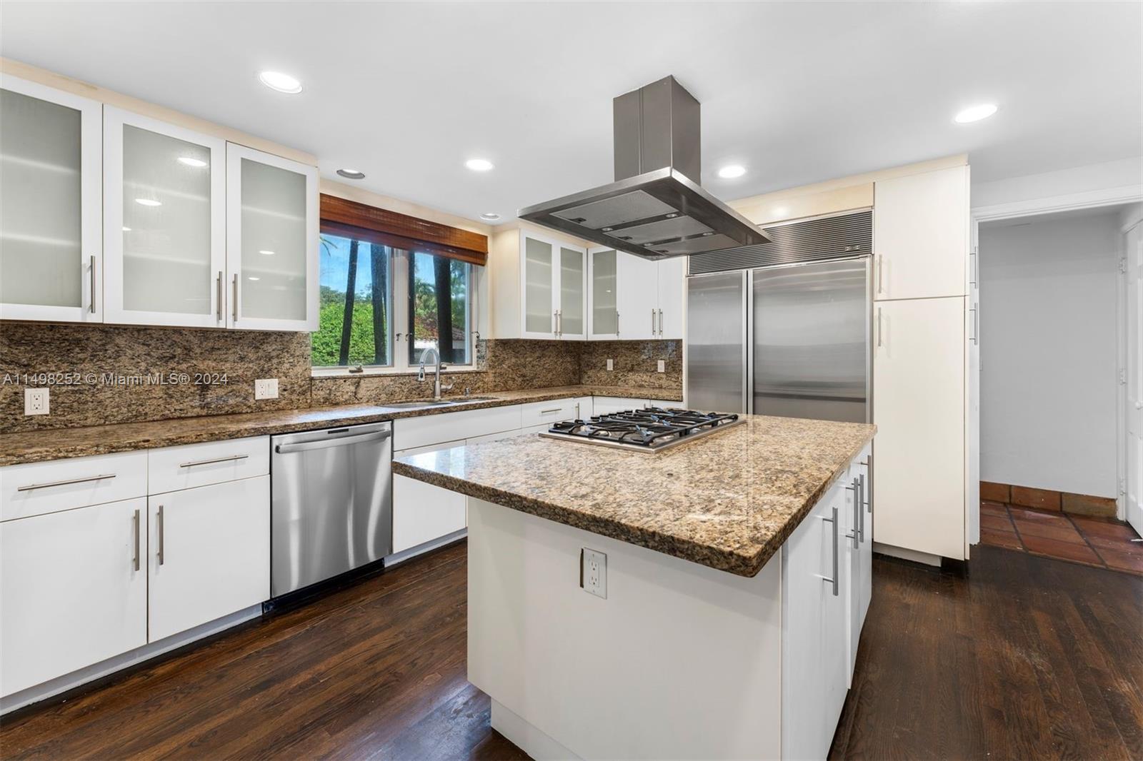 12 Lagorce Circle Miami Beach, FL 33141 - Photo 6 of 23 a kitchen with stainless steel appliances granite countertop a sink stove and refrigerator