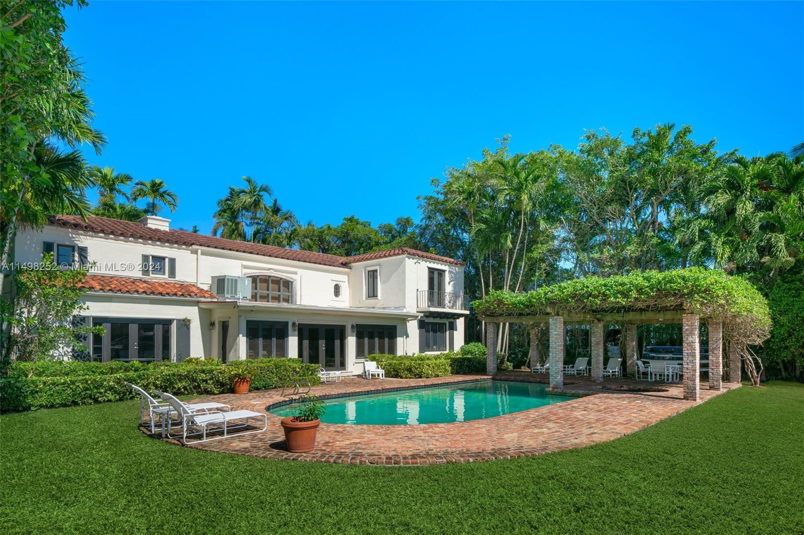 12 Lagorce Circle Miami Beach, FL 33141 - Photo 10 of 23 a front view of a house with a yard table and chairs