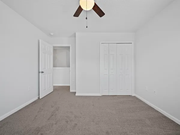 an empty room with a ceiling fan