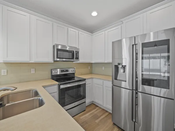 a kitchen with a refrigerator sink and microwave