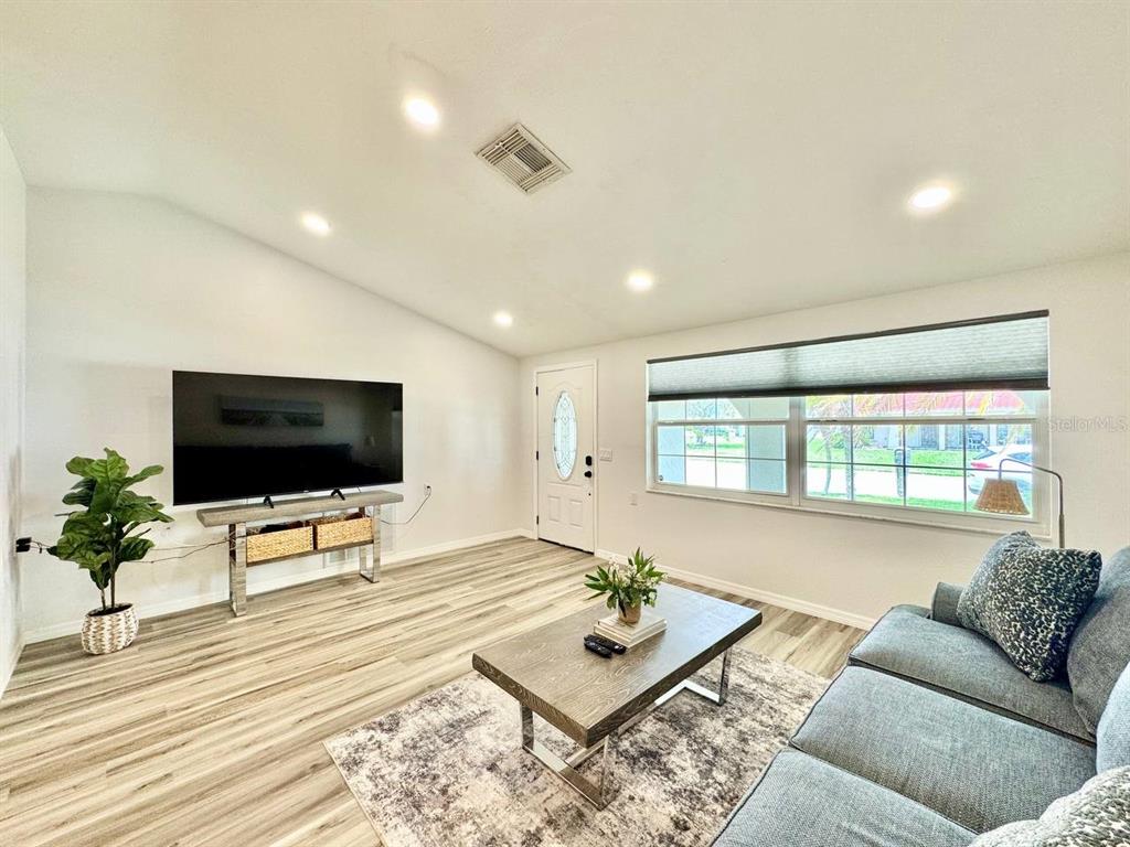 4282 Rudder Way New Port Richey, FL 34652 - Photo 8 of 34 a living room with furniture and a flat screen tv