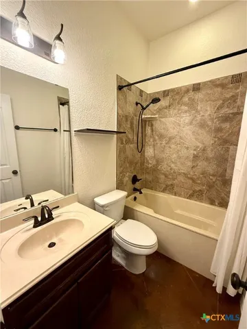a bathroom with a double vanity sink toilet mirror and shower