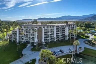 a view of a patio with couches table and chairs and potted plants