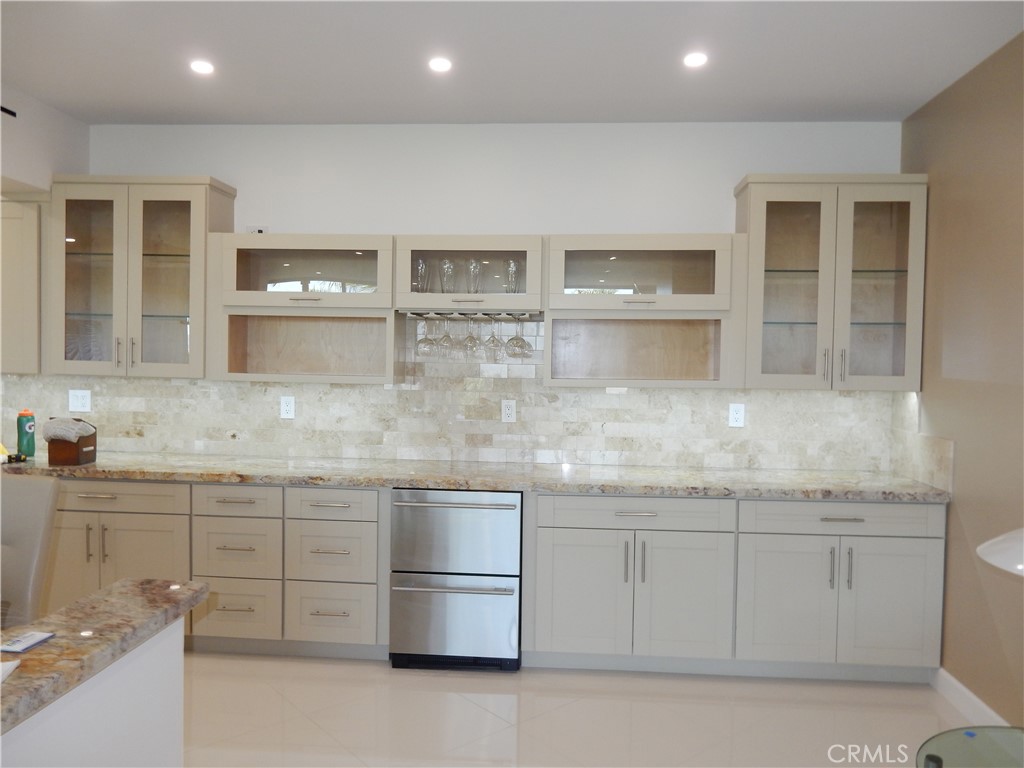 900 Island Drive, Unit 705 Rancho Mirage, CA 92270 - Photo 6 of 25 a kitchen with stainless steel appliances granite countertop a sink and cabinets