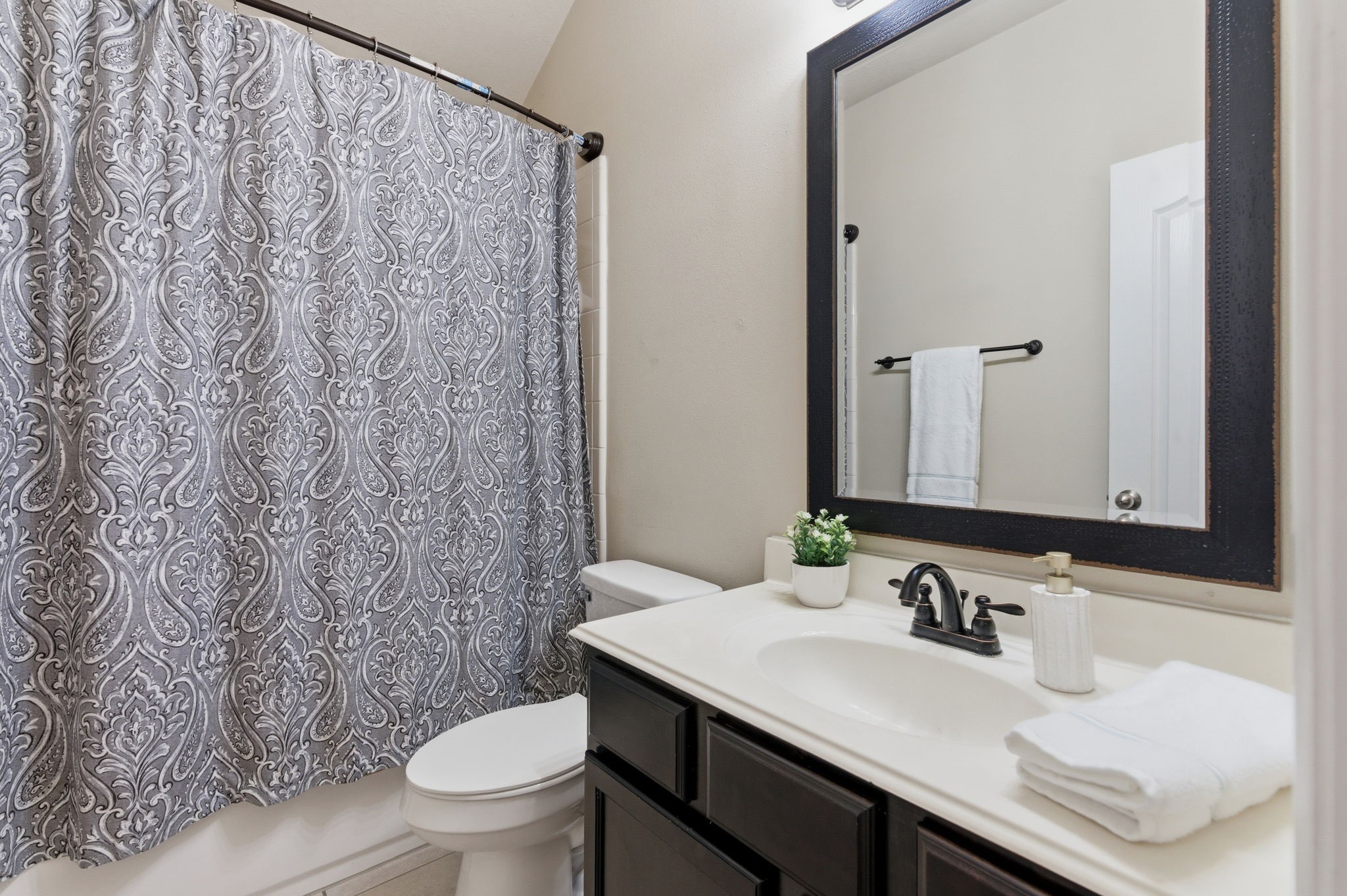 1737 Round Oak Lane Conroe, TX 77304 - Photo 34 of 39 a bathroom with a granite countertop sink and a toilet