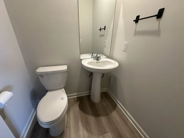 a bathroom with a sink toilet and a mirror
