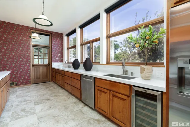 a spacious bathroom with a granite countertop sink and a large window