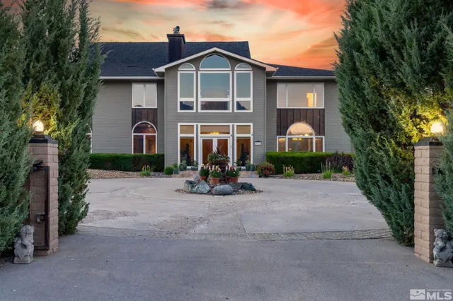 a front view of a house with porch and garden