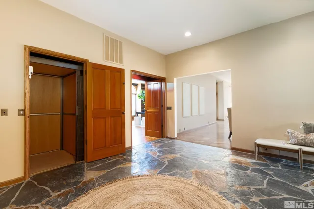 a view of a livingroom with wooden floor and a cabinet